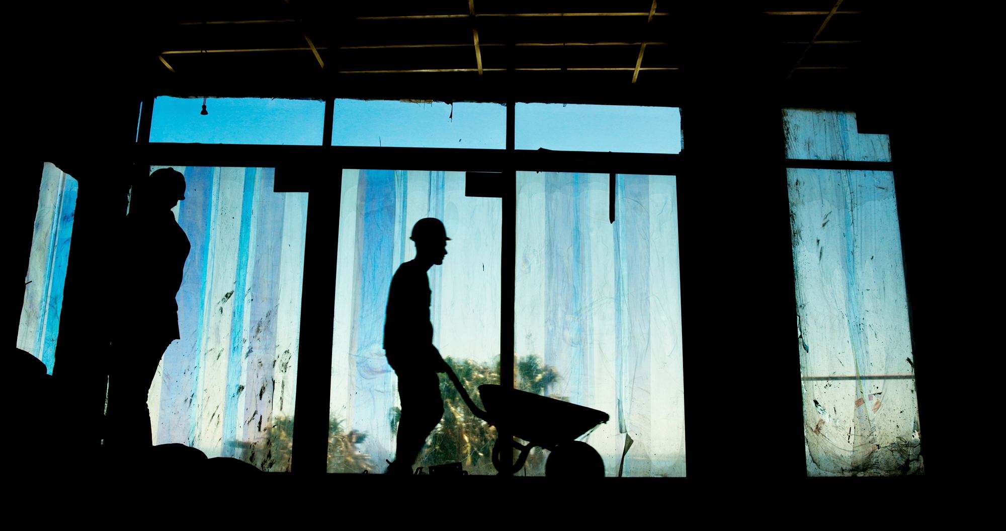 Construction worker on a building site against the light